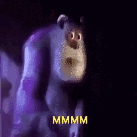 a cartoon character from monsters inc is standing in the dark with the word mmmm written on the bottom .