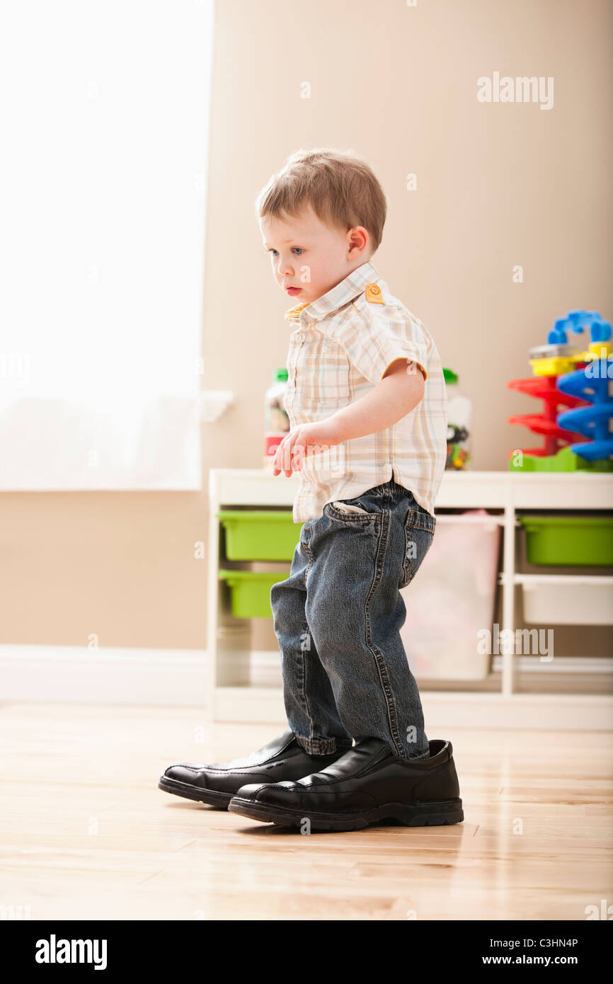 boy-2-3-walking-in-dads-shoes-C3HN4P.jpg