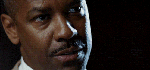 a close up of a man 's face and finger