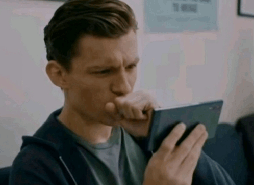 tom-holland-tom-hollond-looking-on-phone.gif