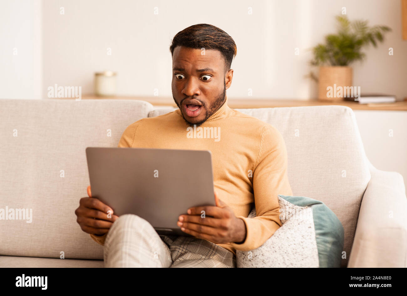 shocked-black-guy-looking-at-laptop-working-at-home-2A4N8E0.jpg