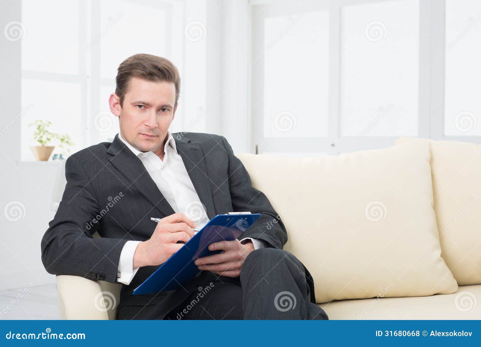 male-psychologist-being-ready-to-take-notes-sitting-couch-31680668.jpg